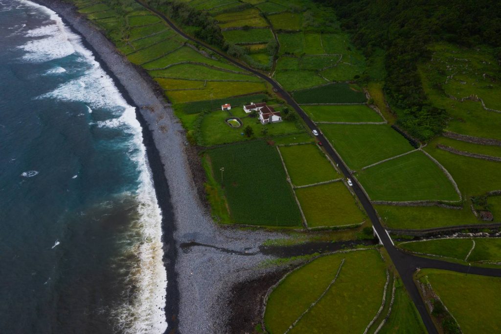 Aerial view of beach near green fields in Flores, The Azores. Walking on the Moon & prepping for climbing Pico