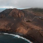 Aerial view of lighthouse near the sea in Horta, The Azores. Walking on the Moon & prepping for climbing Pico