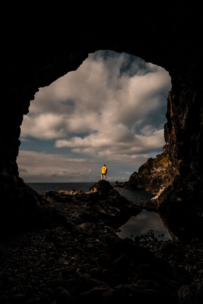 David Simpson outside a cave by the bay in Flores, The Azores. 2 days looking at mist in Flores