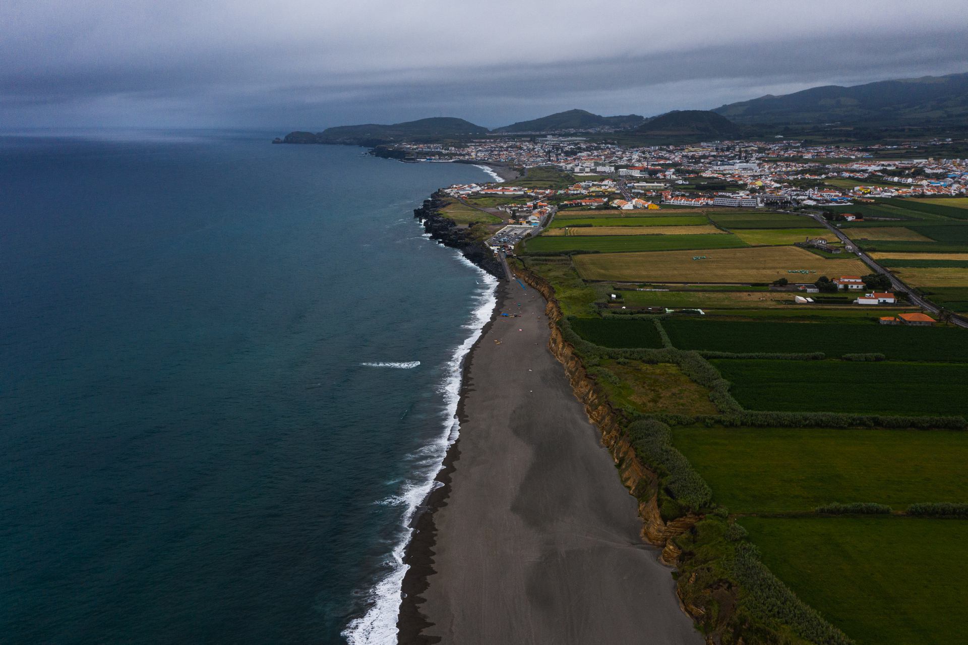 Aerial view of beach by the green fields in Miguel, The Azores. A day on San Miguel