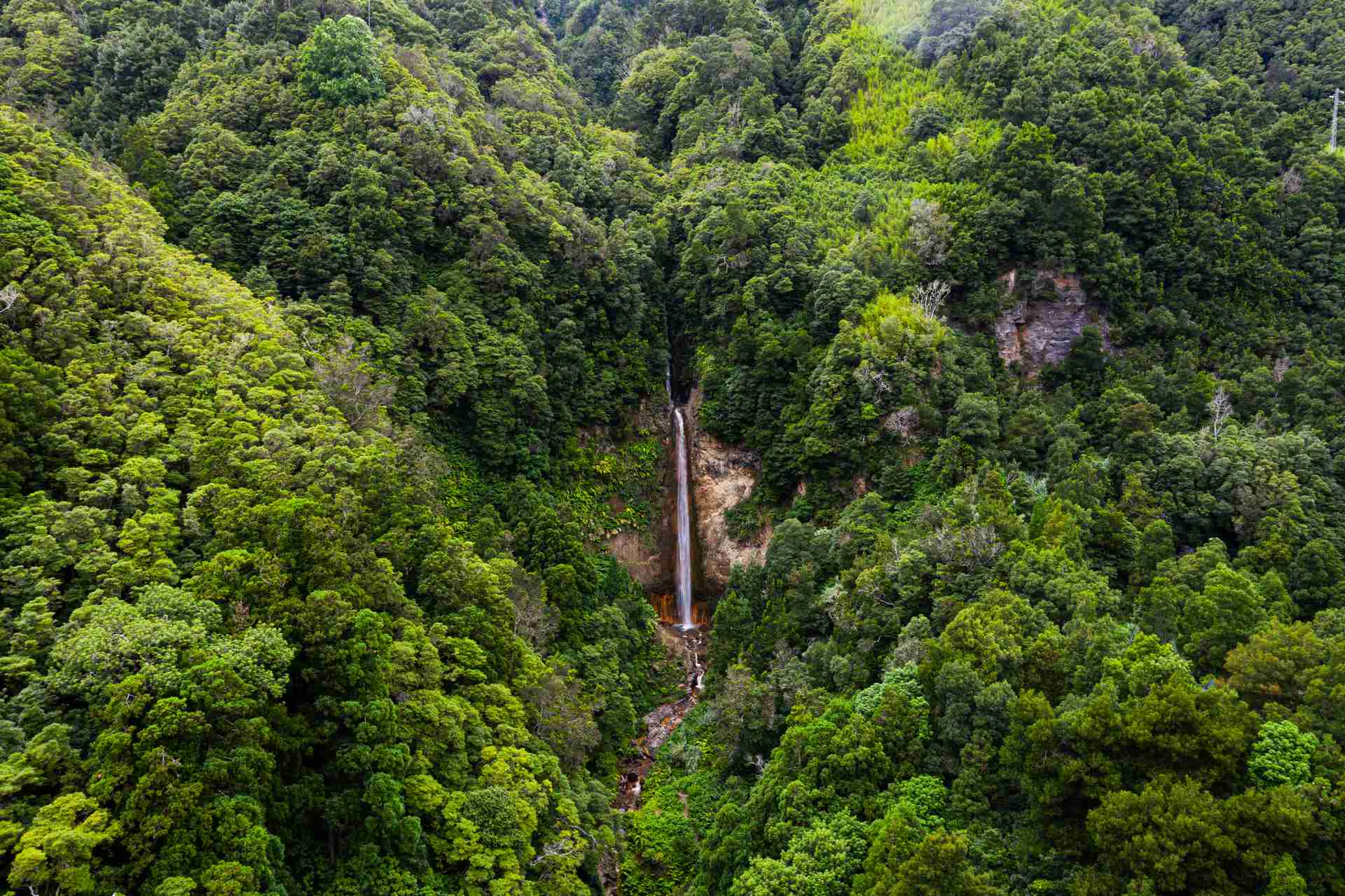 Aerial view of waterfalls in the forest in Miguel, The Azores. A day on San Miguel