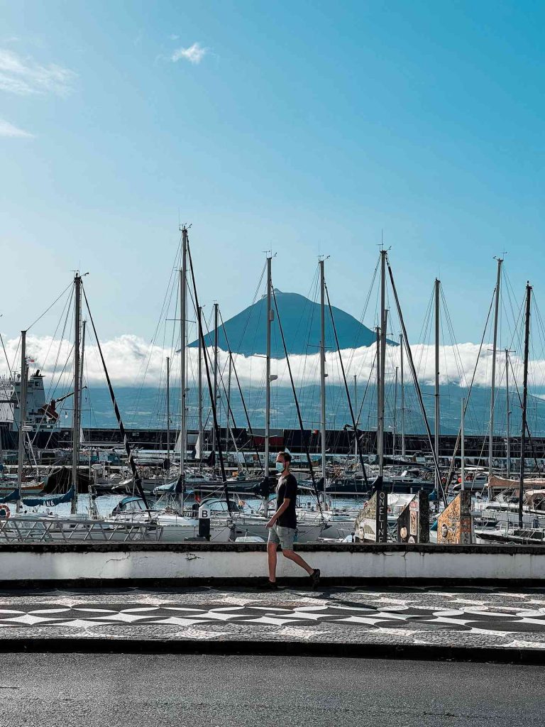 Man walking by the marina in Horta, The Azores. Camping in volcano Pico, Portugal’s highest mountain