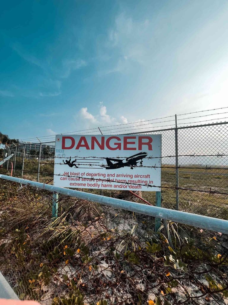 Danger sign by the fence in Sint Maarten. Quading & getting ghosted by my hotel in Dominica