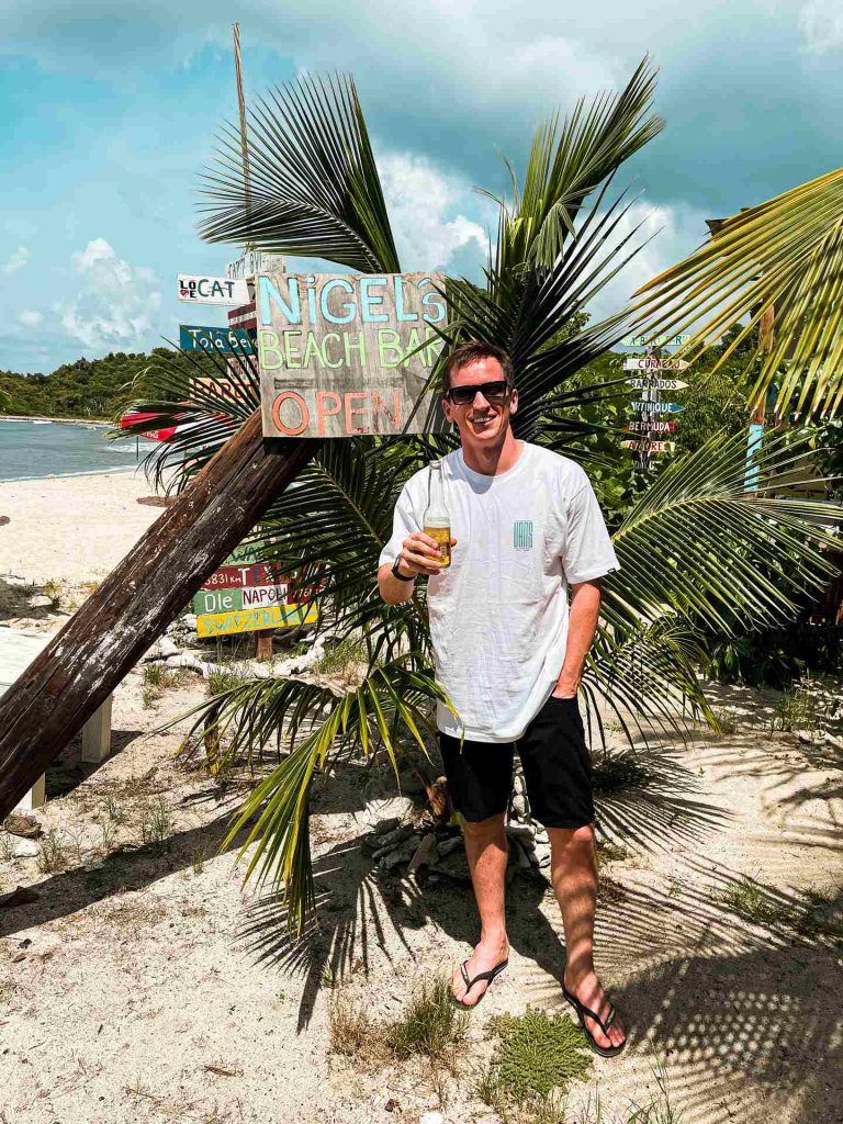 David Simpson drinking beer at Nigel's Beach bar in British Virgin Islands. BVI has me