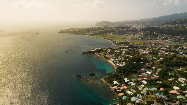 Aerial view of houses, trees and the sea in Saint Vincent and the Grenadines. Quarantine detour!