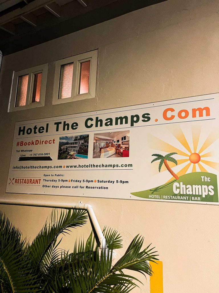 Hotel The Champs signage by the tree in Dominica. The start of a Covid nightmare