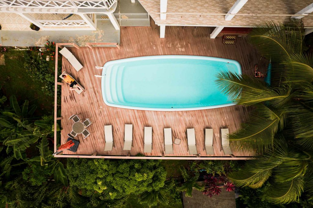 Aerial view of pool at roof deck among the trees in Dominica. The start of a Covid nightmare