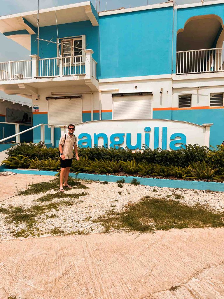 David Simpson standing infront of a building in Anguilla. Unexpected access into Anguilla
