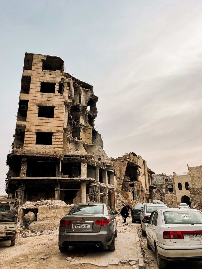 Cars near war damaged buildings in Aleppo. A day in Aleppo and generosity of new friends
