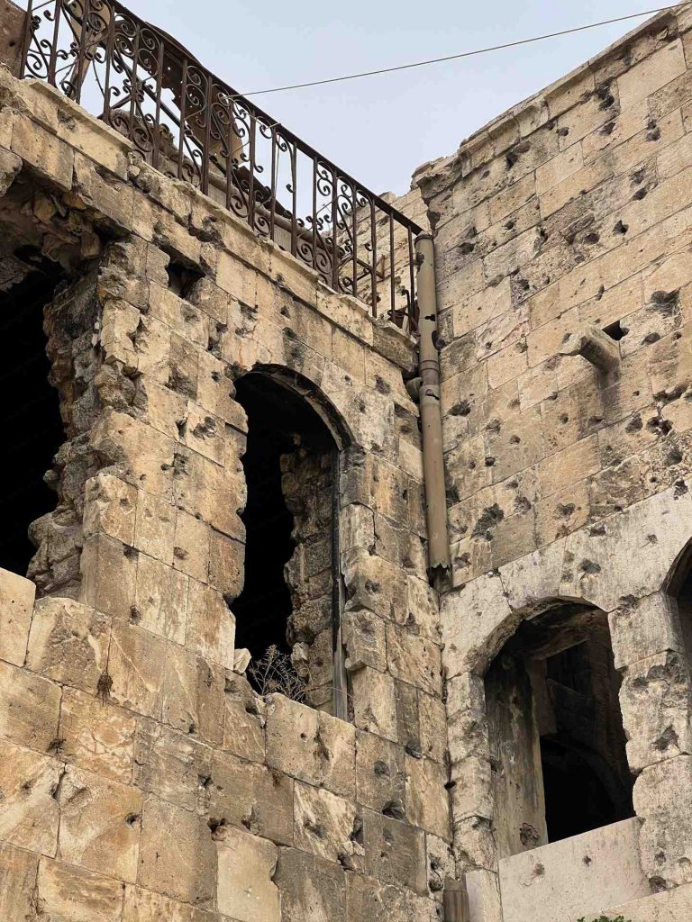 Bullet holes in war damaged building in Aleppo. A day in Aleppo and generosity of new friends