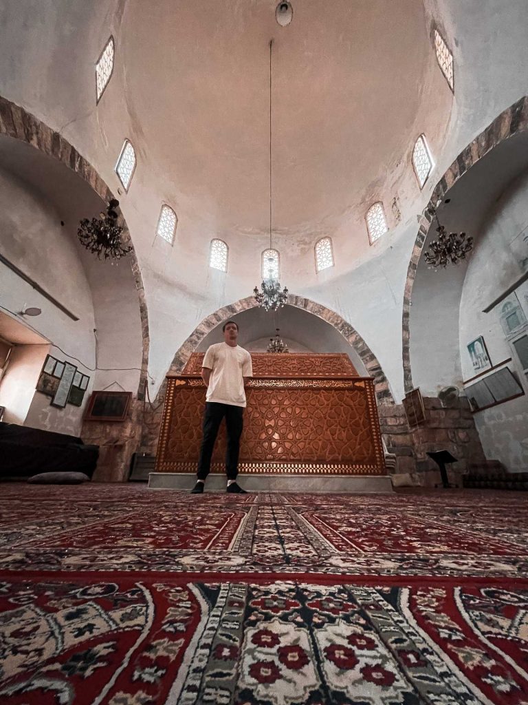 David Simpson standing on carpet inside mosque in Hama in Aleppo. A day in Hama, Syria