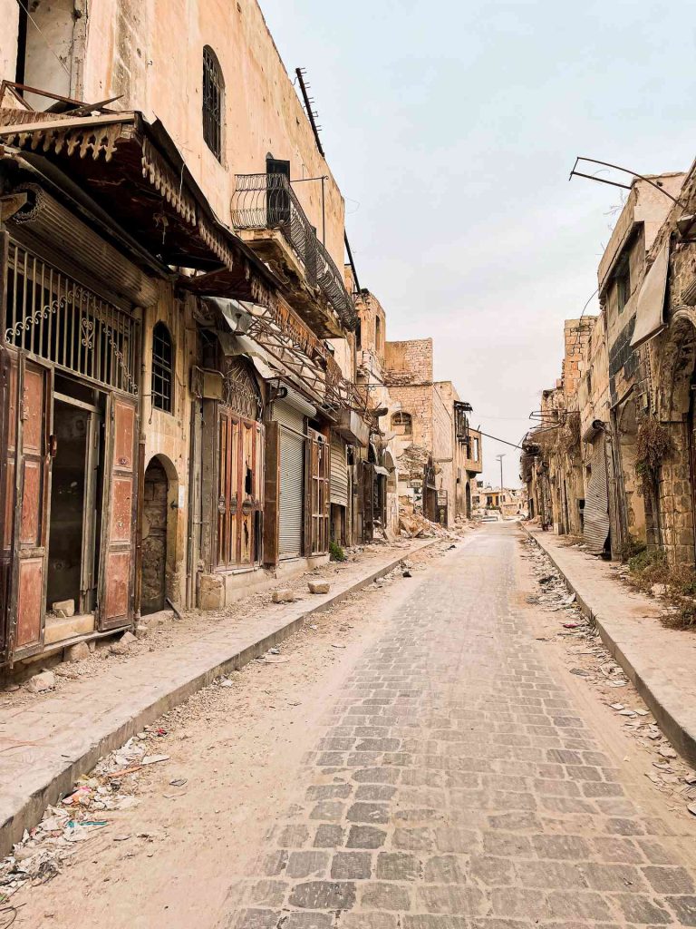 Rubble near war damaged buildings in Aleppo. A day in Aleppo and generosity of new friends