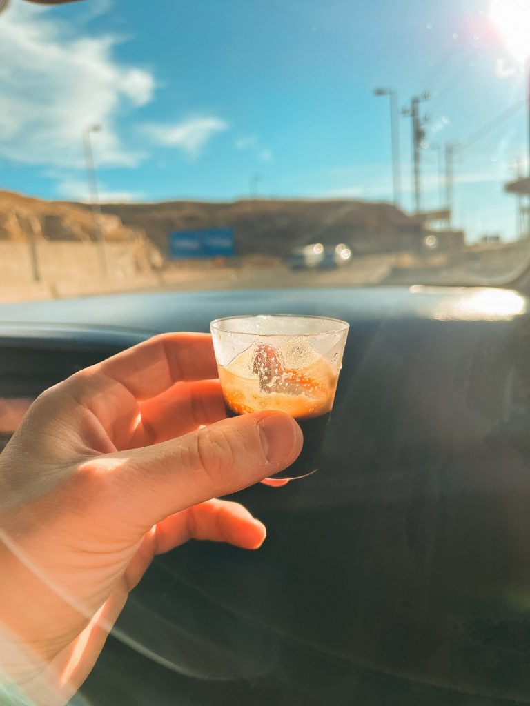 Small glass of coffee during road trip in Syria. Driving into Syria