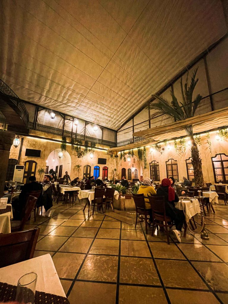 Busy restaurant full of people in Hama in Aleppo. A day in Hama, Syria