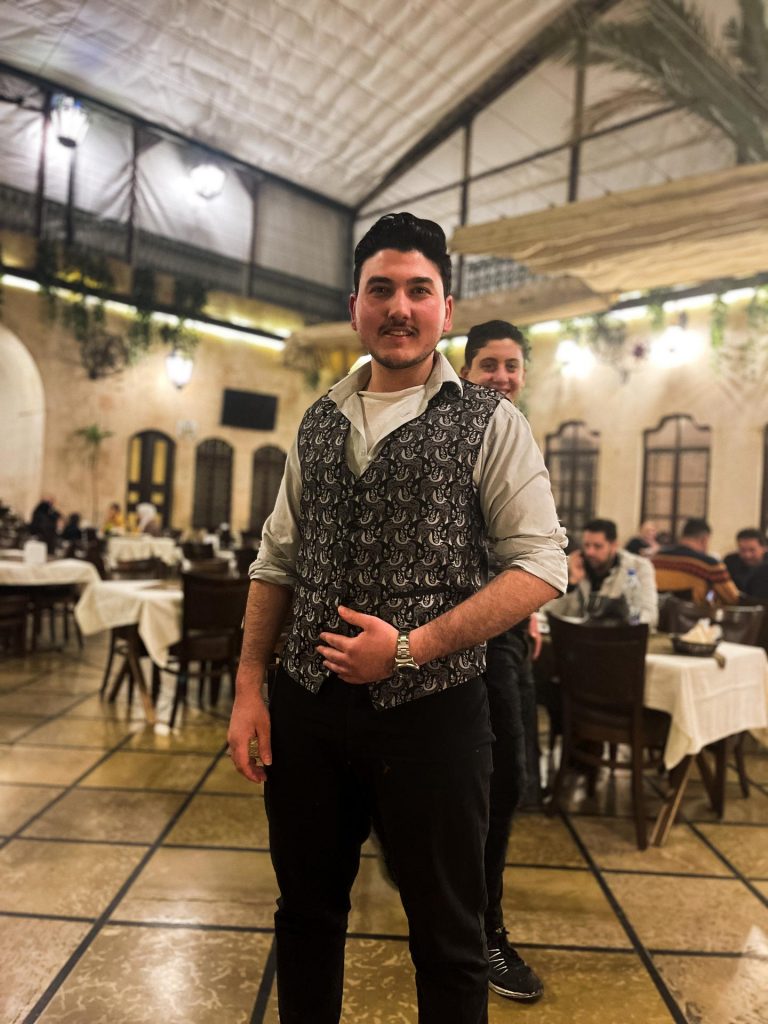 Local waiters at restaurant in Hama in Aleppo. A day in Hama, Syria