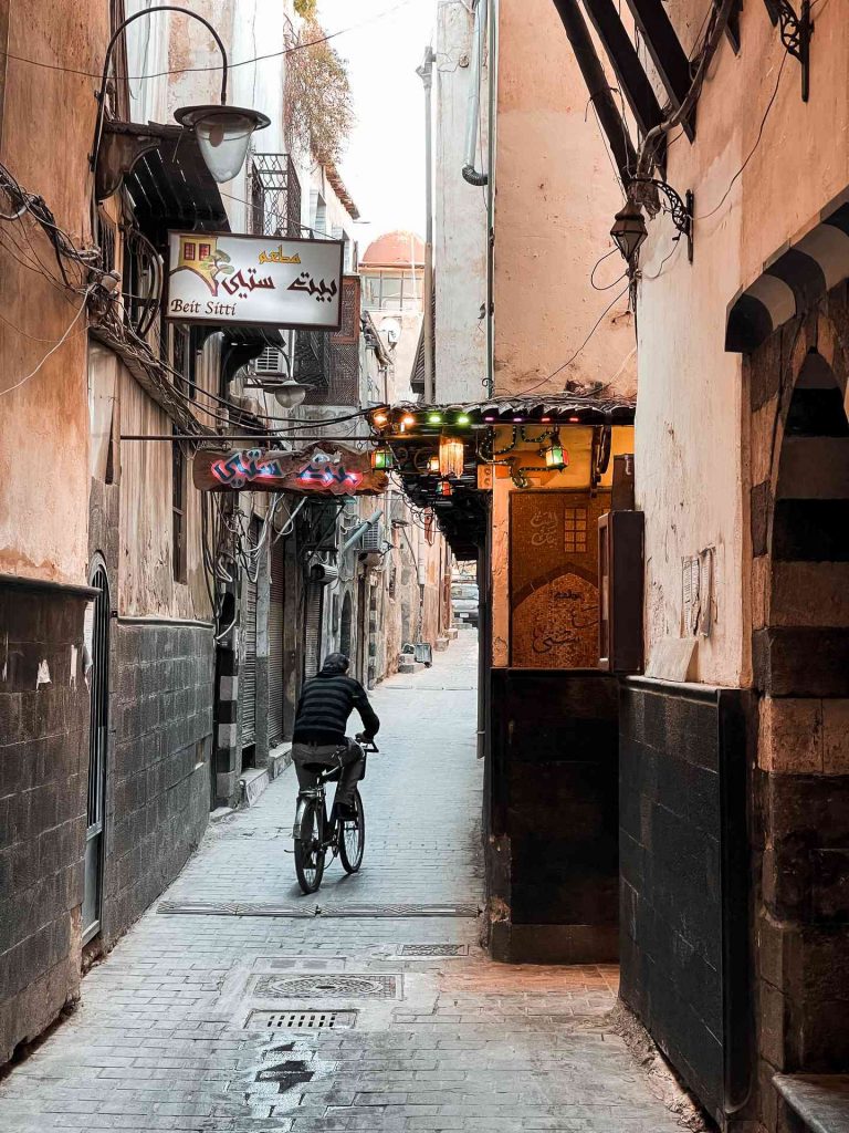 A local man biking thru the alley in Damascus, Syria. A day in Damascus