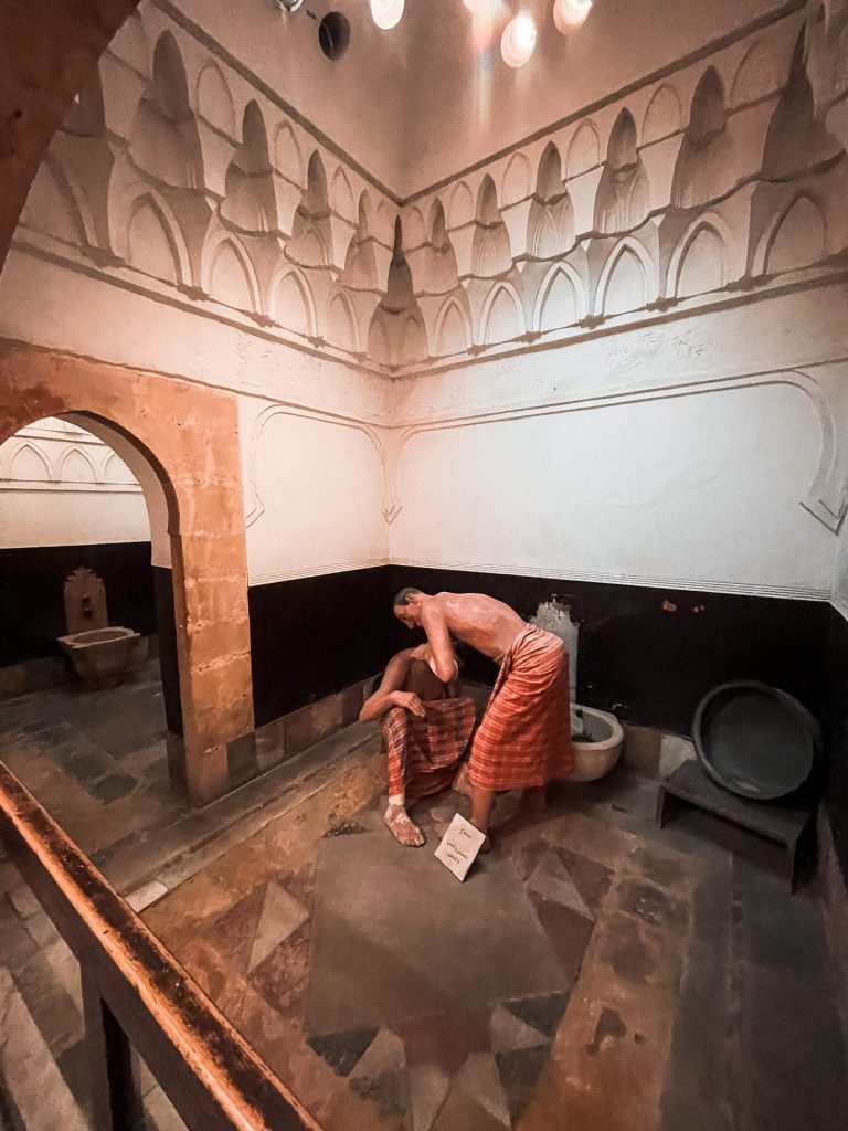 Wax figures of two men bathing inside the museum in Damascus, Syria. A day in Damascus