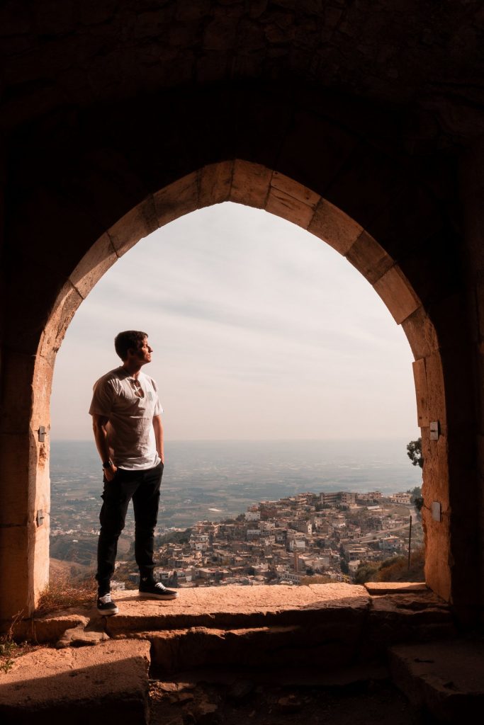 David Simpson standing on window viewing the city. The Syrian Series reflection post