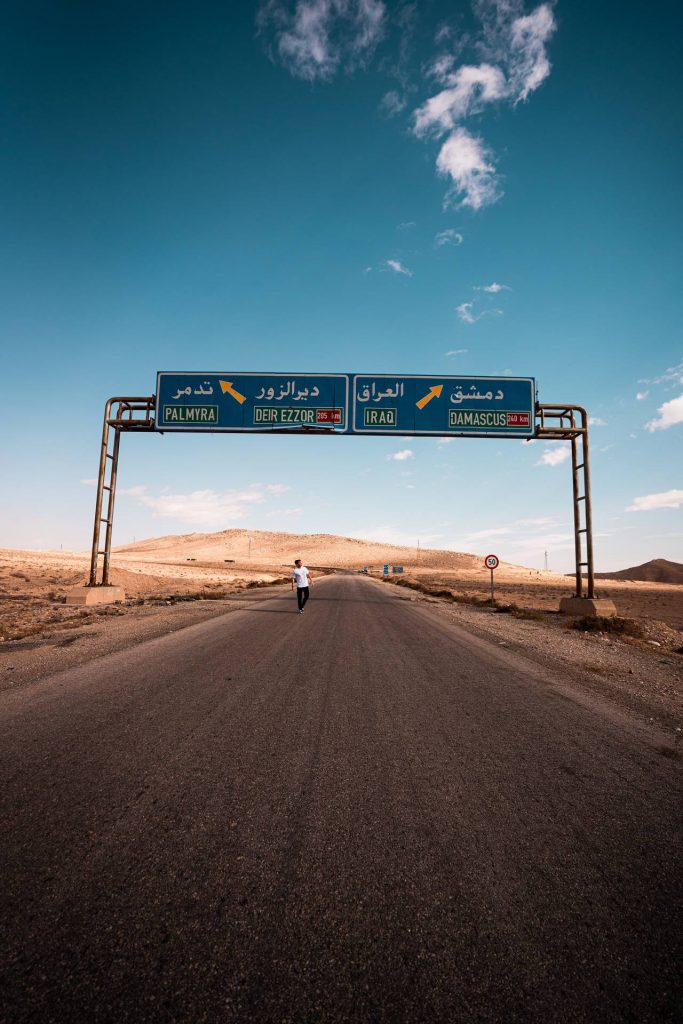 David Simpson walking on highway to Palmyra mand Damascus. The Syrian Series reflection post