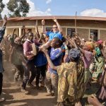 David Simpson being carried on shoulders by Batwa people in Burundi. The East African Series photo album