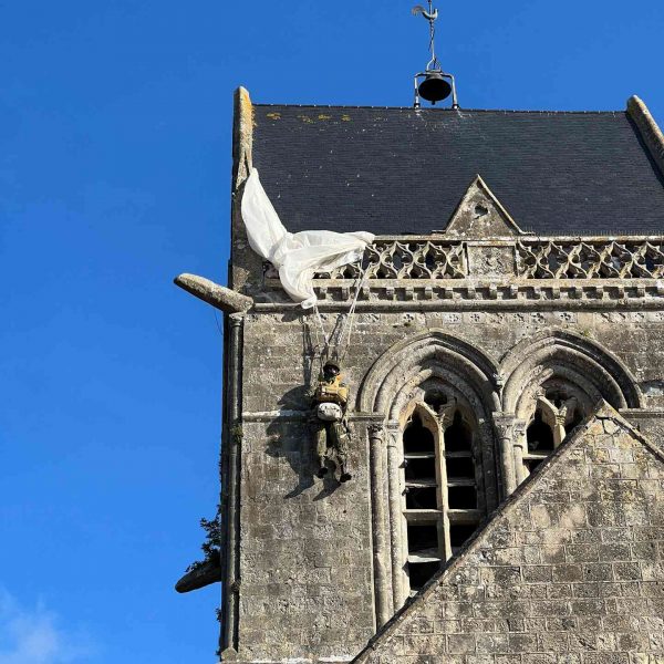 Dummy exhibit of troop dangling on church roof in Airborne Museum in Sainte Mere Eglise in Normandy, France. The best steak & omelette in the world in the same day
