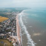 Aerial view of houses along the beach in Normandy, France. The Normandy & Western Front series reflection post