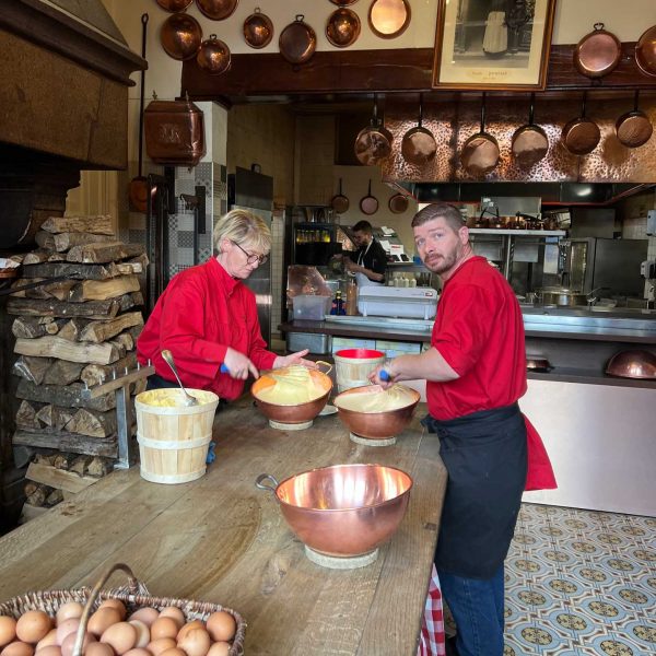 Kitchen workers in Mont Saint Michel Abbey in Normandy, France. The best steak & omelette in the world in the same day