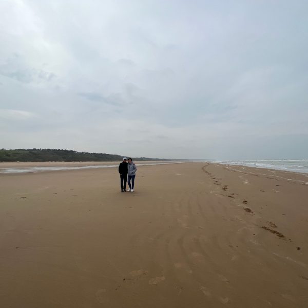 Mom and dad at beach in Longues Sur Mer Battery in Normandy, France. Is there any such thing as a good beach in Normandy?