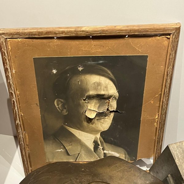 Destroyed portrait of Hitler in Caen Memorial in Normandy, France. The best viewpoint, museum and cafe in France