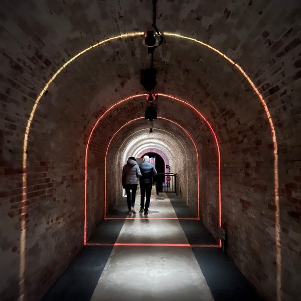 Mom and dad walking the corridor at Underground Citadel in Verdun, France. Verdun, Riems & Champagne
