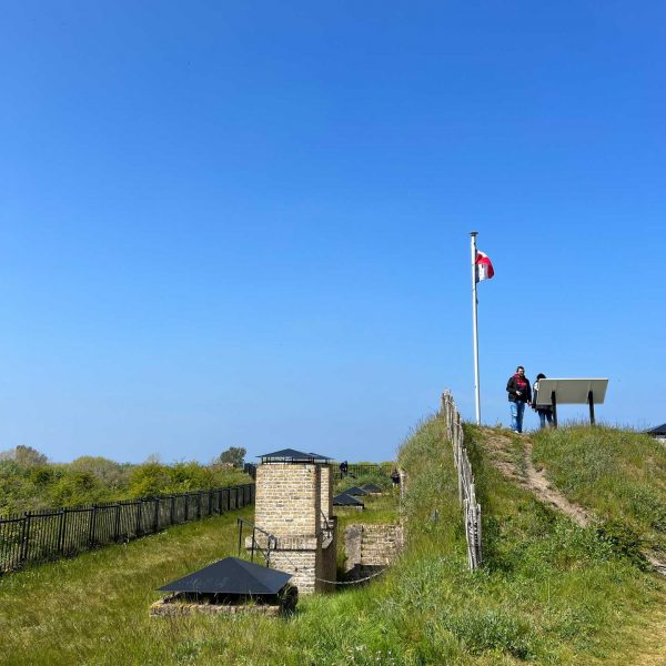 Flag and people in Lijssenthoek Cemetery, Belgium. The escape of Dunkirk