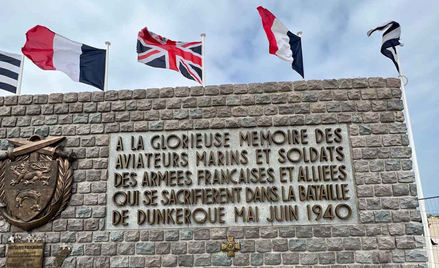 Memorial marker with flags in Dunkirk, France. The escape of Dunkirk