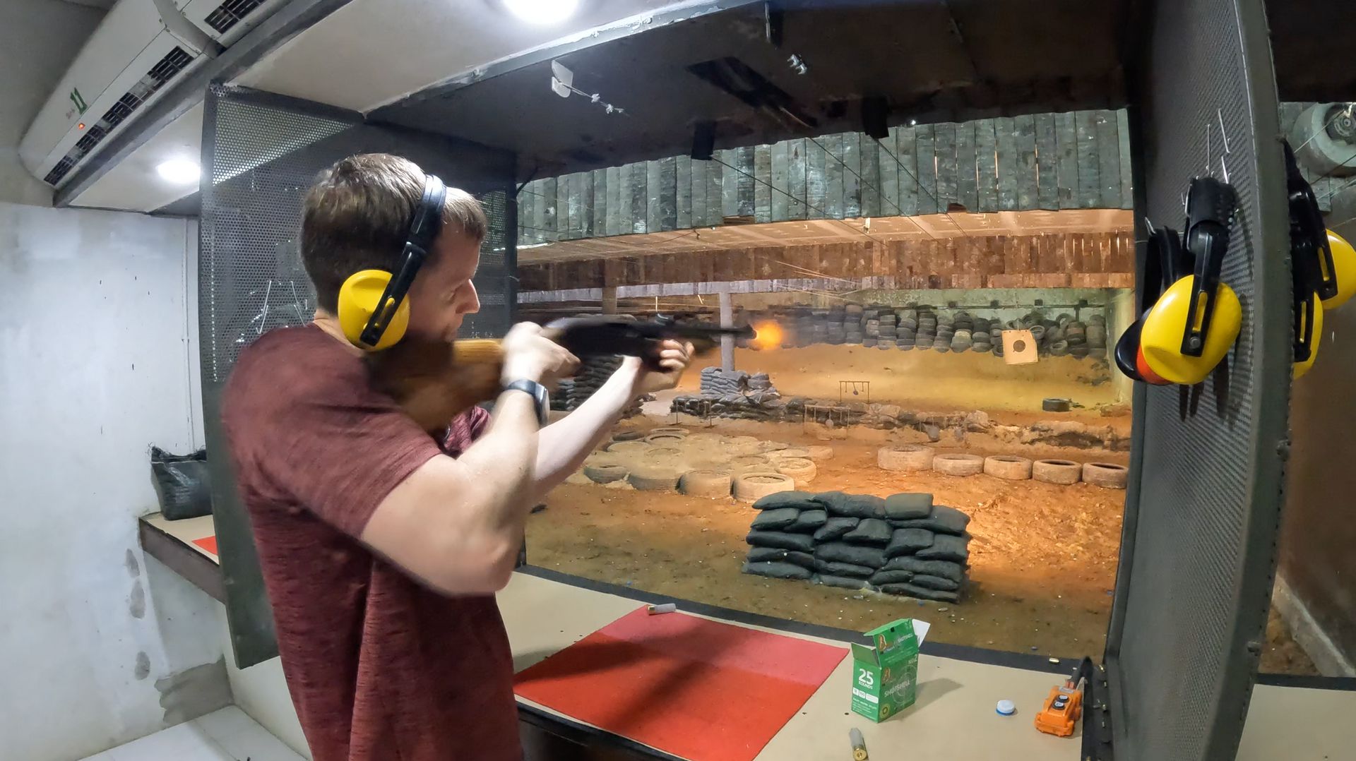 David Simpson shooting a target at shooting range in Thailand. Shotguns, markets and temples in Bangkok