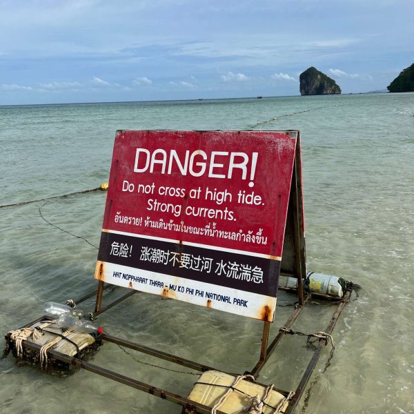 Warning sign at the beach in Thale Waek in Thailand. Boat ride from hell, island hopping from heaven
