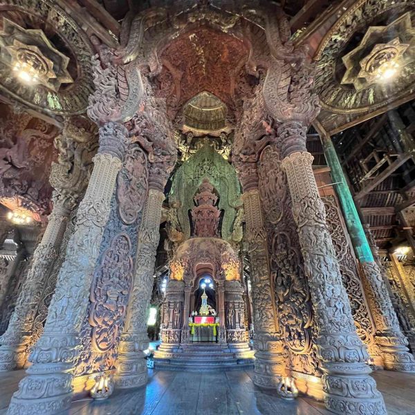 Shrine and woodcarvings at Sanctuary of Truth in Pattaya, Thailand. A Mcdonalds feast and the Sanctuary of Truth