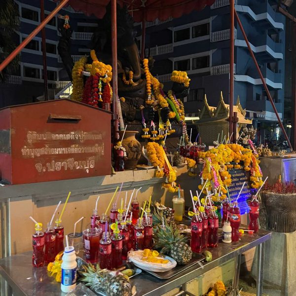 Deity offered food and drink in Pattaya, Thailand. A Mcdonalds feast and the Sanctuary of Truth