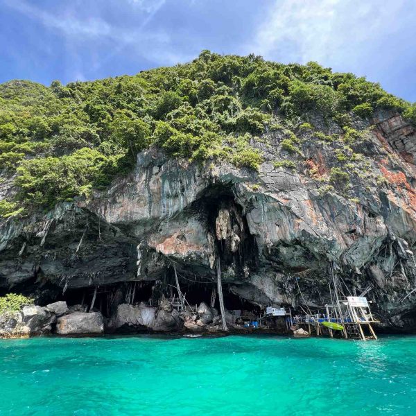Wooden dock at cliffs at Pileh Bay in Thailand. Boat ride from hell, island hopping from heaven