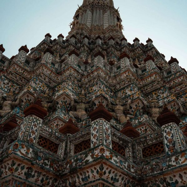Ornamental sculptures of Wat Arun in Thailand. Shotguns, markets and temples in Bangkok