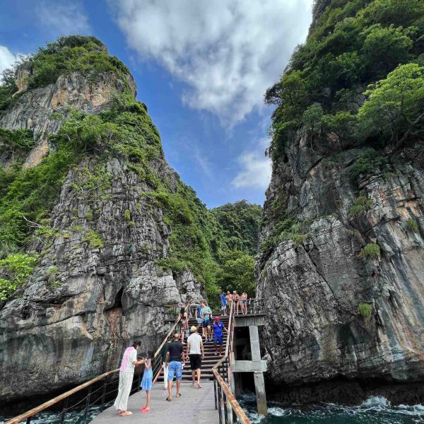 Bridge between cliffs at Maya Bay beach in Thailand. Boat ride from hell, island hopping from heaven