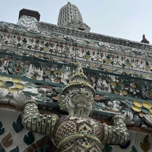 Ornamental sculptures of Wat Arun in Thailand. Shotguns, markets and temples in Bangkok