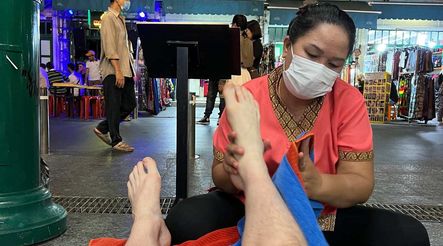 Masseuse massaging David Simpson's feet at Khaosan Road in Thailand. Grand Palaces, ear orgasms and Khaosan Road