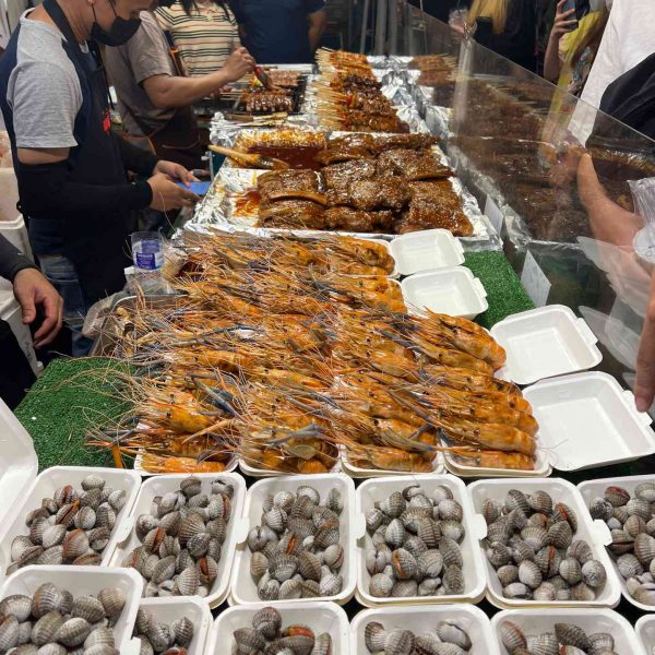 Fresh seafood stall at Jodd Fairs in Bangkok, Thailand. Insects a la carte & a broken bus