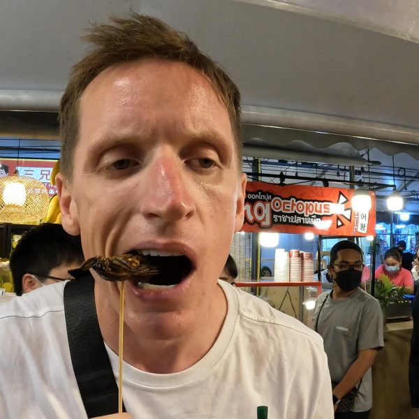 David Simpson eating insects at Jodd Fairs in Bangkok, Thailand.