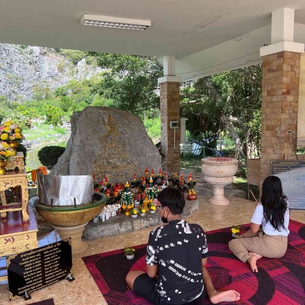 Thai worshippers at shrine near Buddha Mountain in Khao Chi Chan, Thailand. Buddha Mountain, floating market, Golden Buddha, ear spa & an Imperial Massage