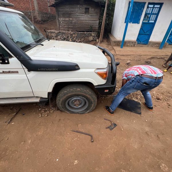 Local guy fixing flat tire in Bukavu, DRC. Gorillas & sleeping with the general’s wife