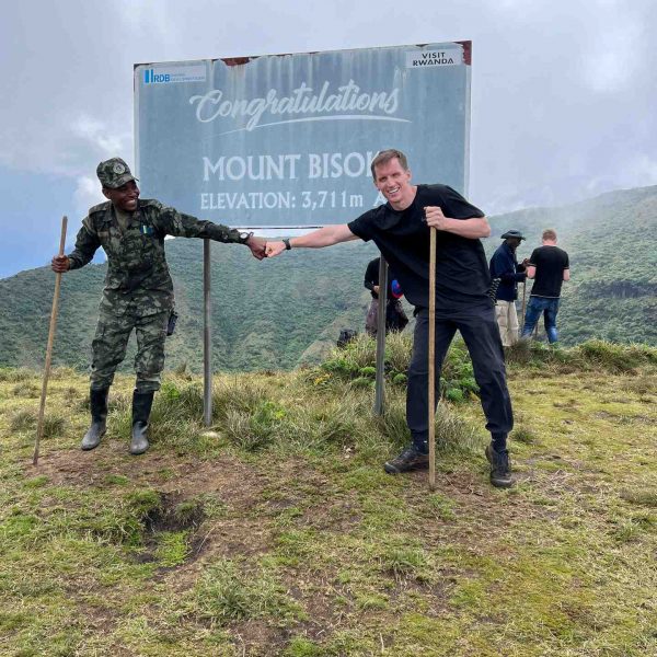 David Simpson and ranger on Mt. Bisoke summit in Rwanda. Climbing Mt Bisoke