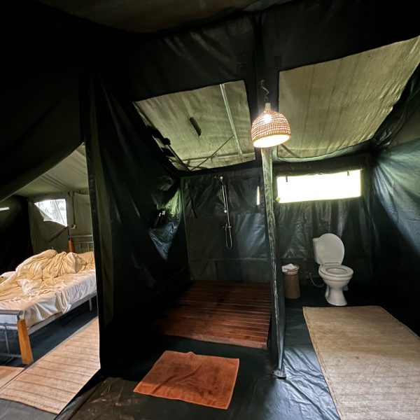 Bedroom and bathroom inside tent accommodations in Tchegera Island, DRC. Checkpoint trouble and Tchegera Island all alone