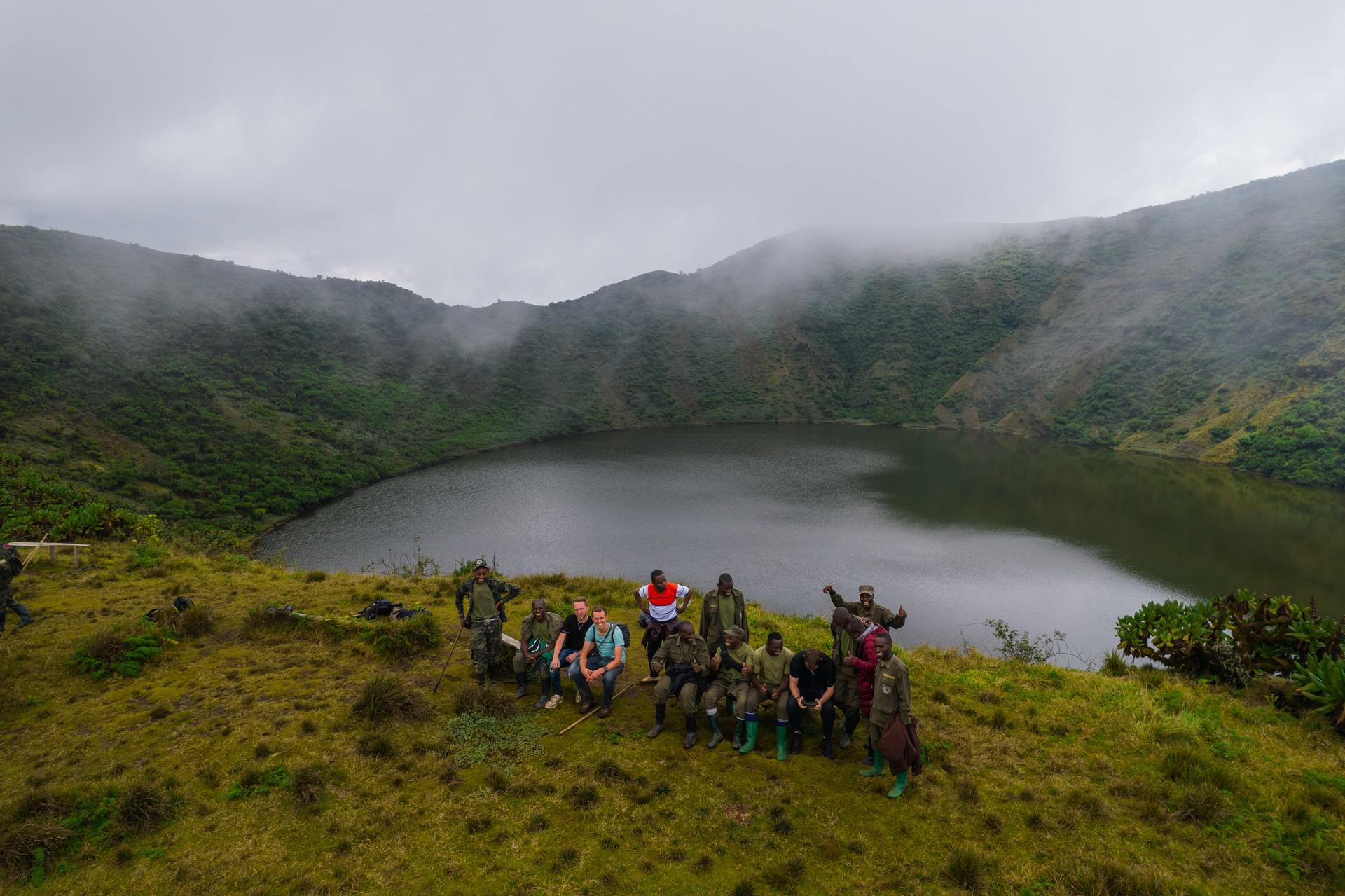 Local rangers and tourists on Mt. Bisoke summit in Rwanda. Climbing Mt Bisoke