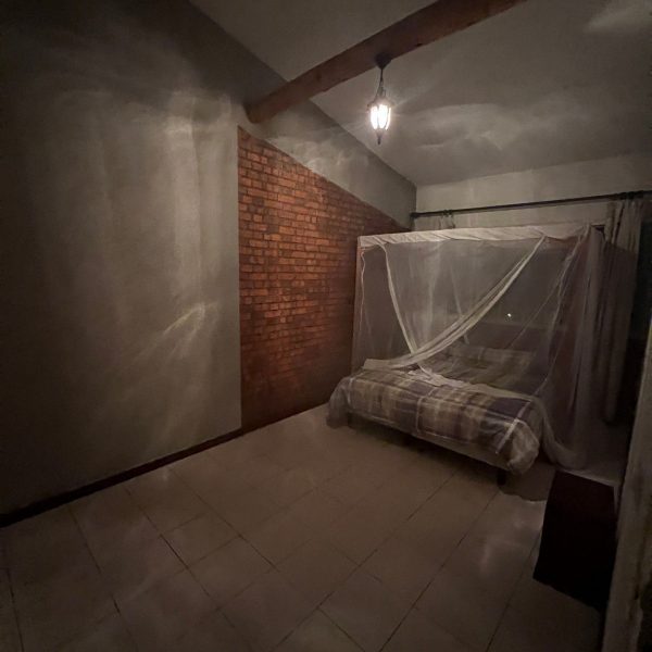 Mosquito net at hostel bedroom accommodations in Burundi. A riot with the Royal Drummers and Batwas of Burundi