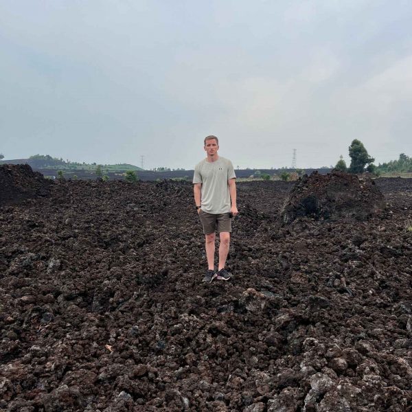 David Simpson standing on cooled lava from volcano in Goma, DRC. Deep into the DRC